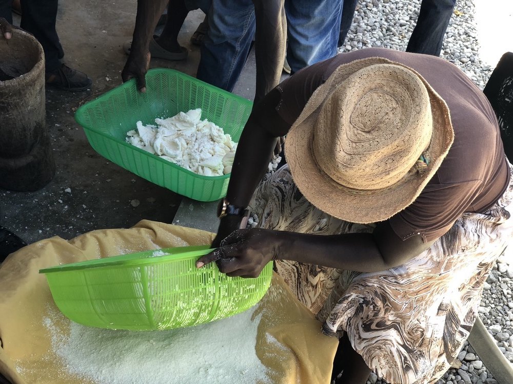 woman pressing cassava