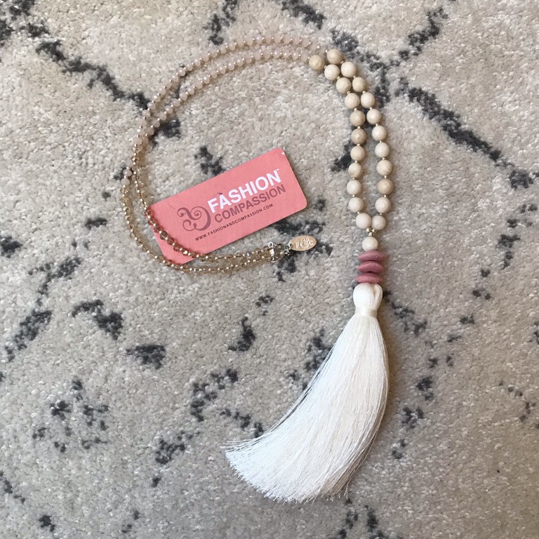long beaded necklace with tassel at end