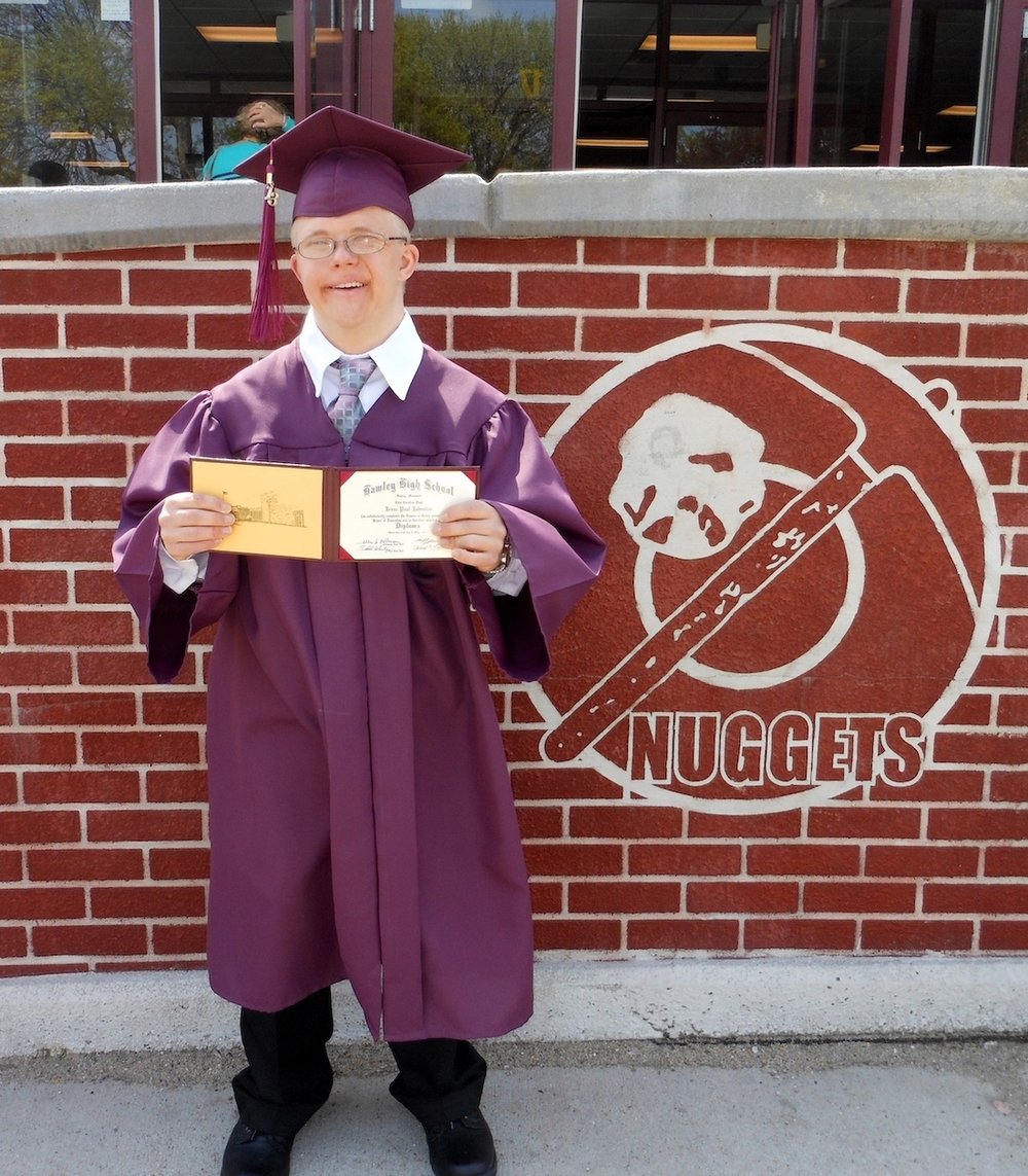 man with down syndrome graduating high school