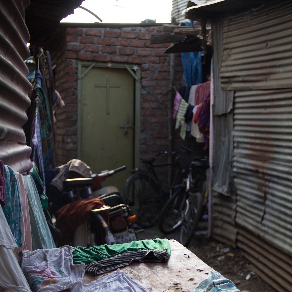 Christian cross on door in slum