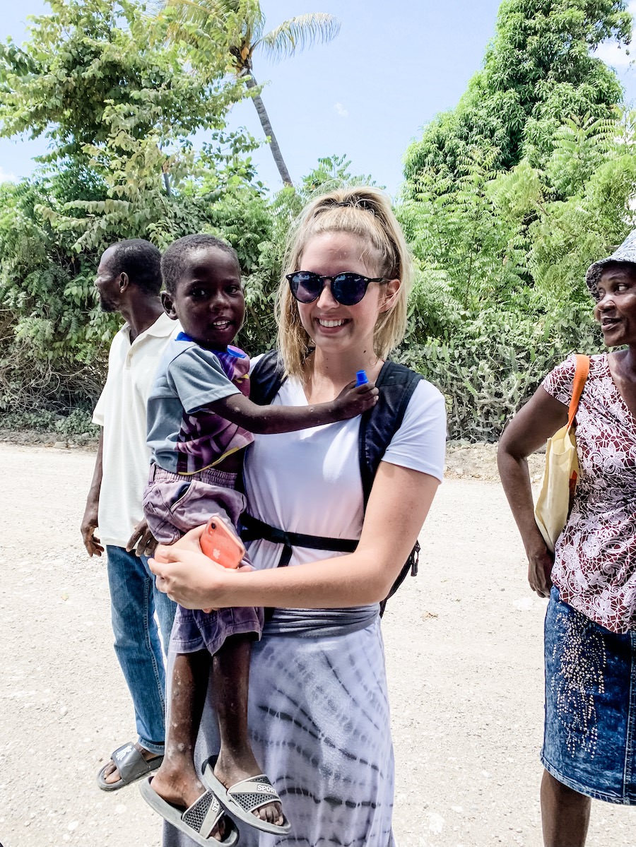 girl holding Haitian boy