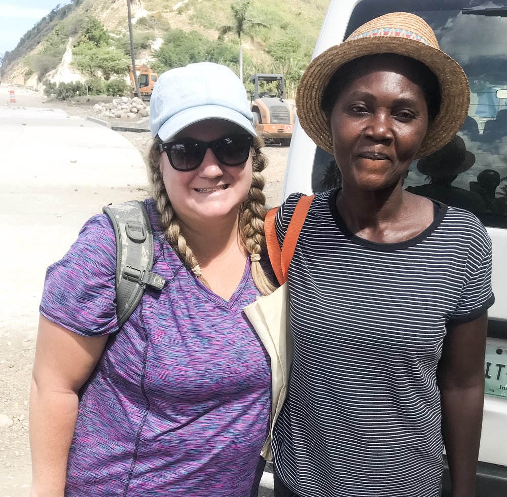 American woman and Haitian woman smiling for camera