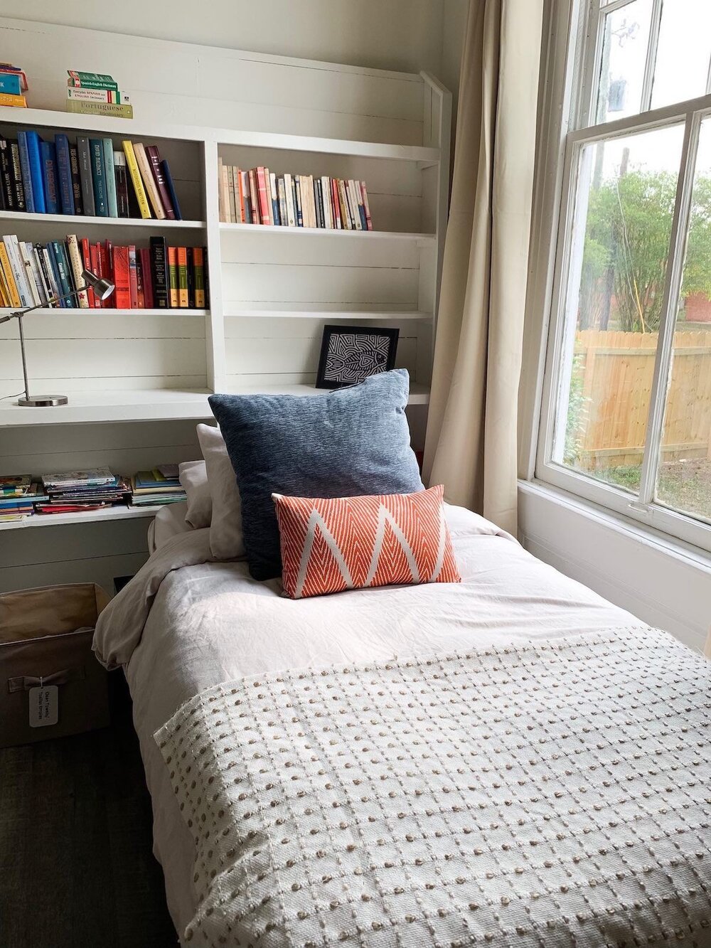 twin bed and bookshelves