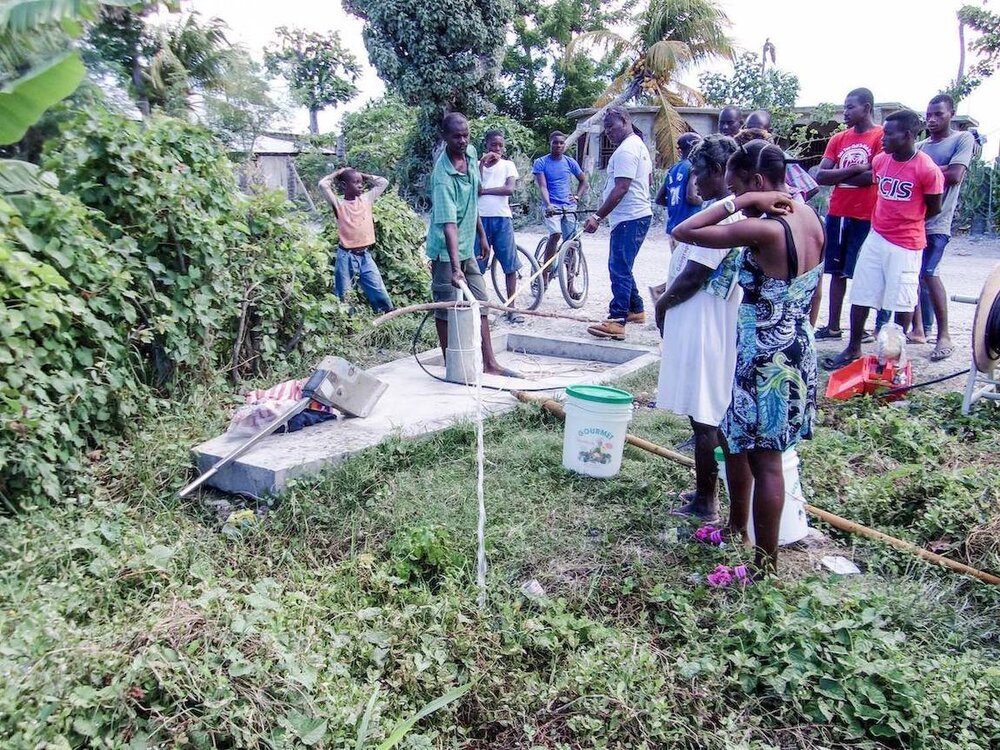 People tapping into Haiti water well for the first time