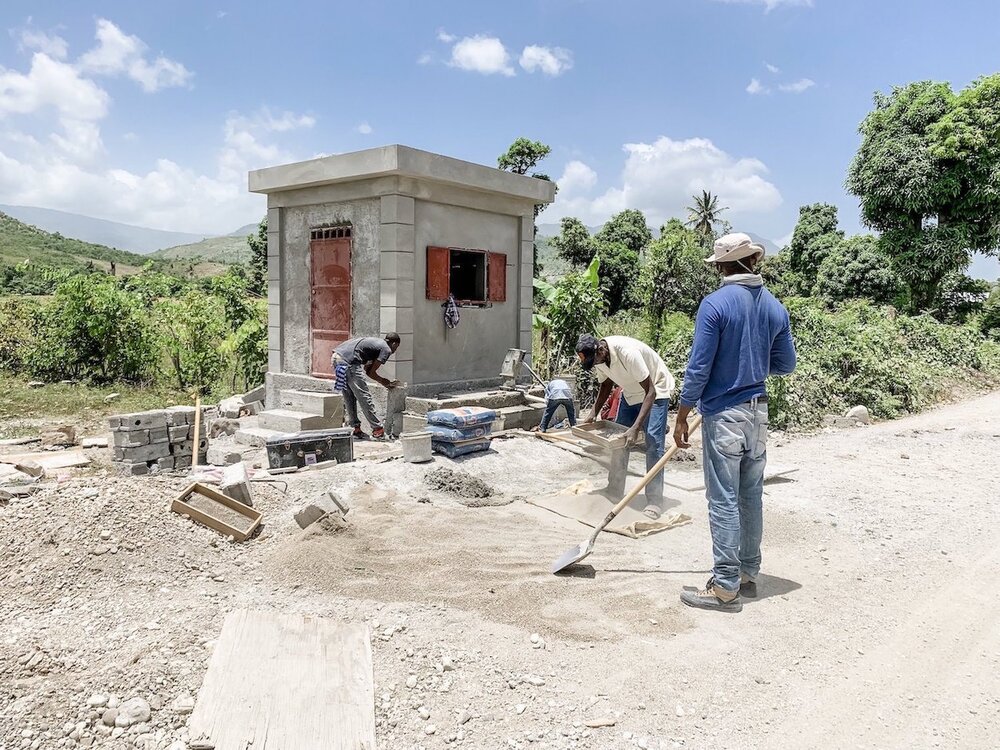 men building water well in Haiti