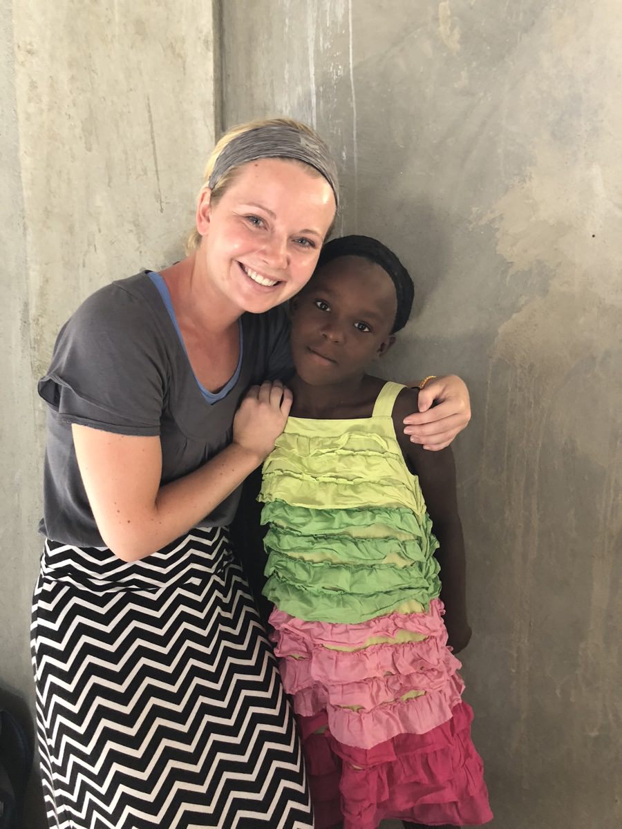 woman and Haitian girl standing together