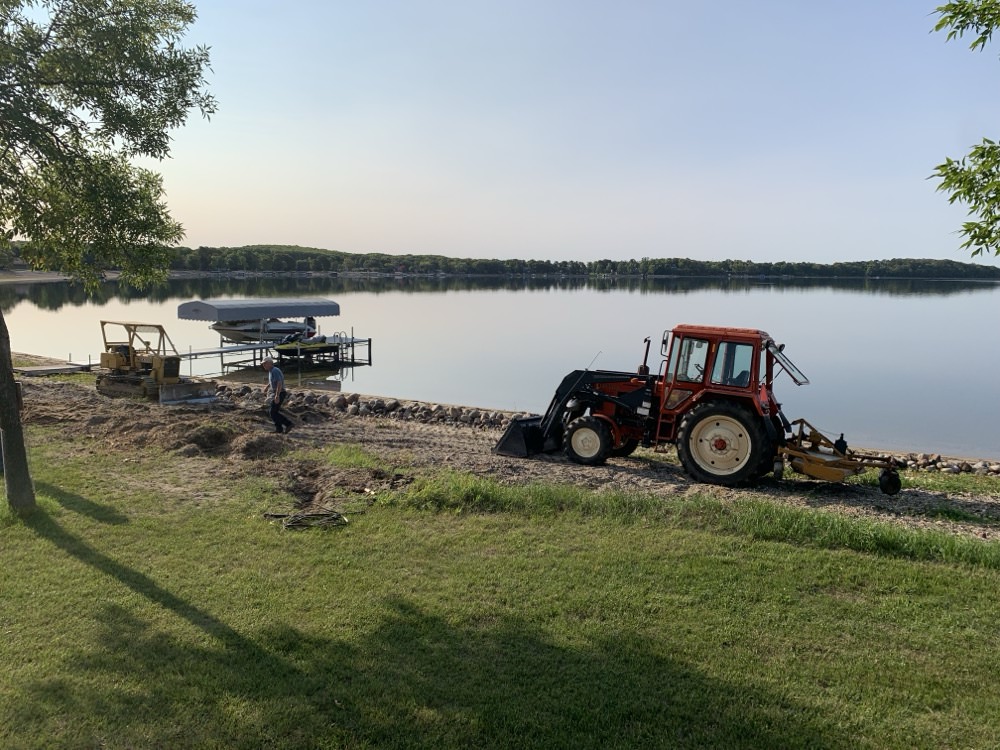 Our lake association worked on a multi-year project to install an outlet to control the water level. Once the water went down, it was time to begin restoring the beach back to how it used to be!